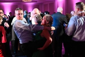 group hugging and dancing at wedding